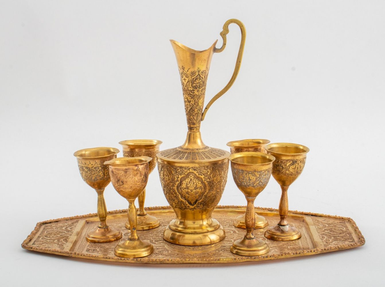 Appraisal: EGYPTIAN ENGRAVED BRASS CORDIAL SET Egyptian engraved brass cordial set