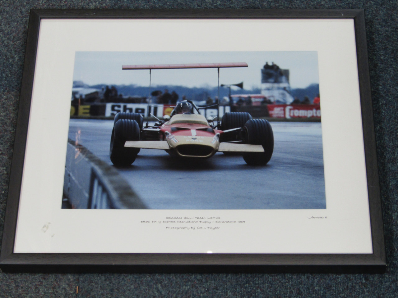 Appraisal: A Jarrotts motoring print of Graham Hill - Team Lotus