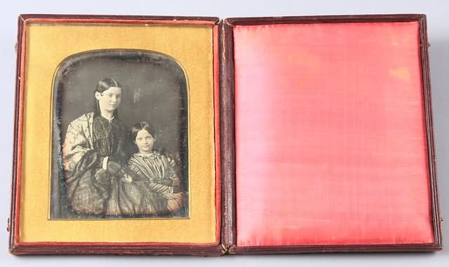 Appraisal: Half plate daguerreotype housed in larger case of woman and