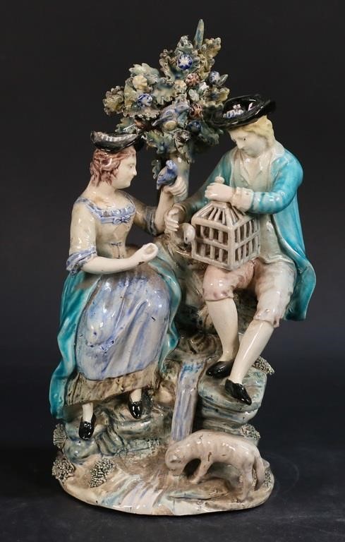 Appraisal: Porcelain figure group couple with birdcage with bocage background Possibly