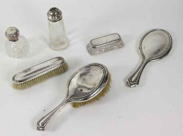 Appraisal: A silver backed three-piece dressing table set Walker Hall Sheffield