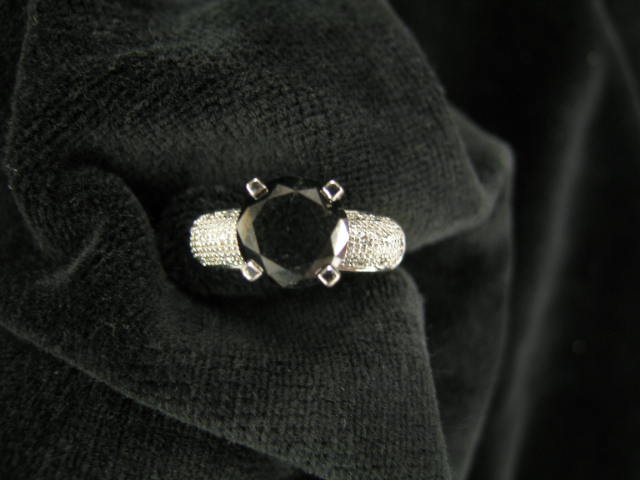 Appraisal: Black Diamond Ring carat round diamond with smaller white diamonds