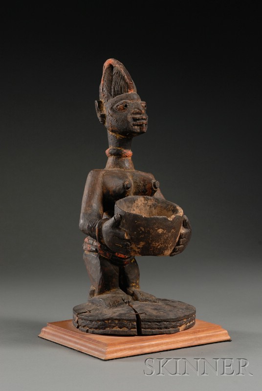 Appraisal: African Carved Wood Female Figure Yoruba the standing figure holding