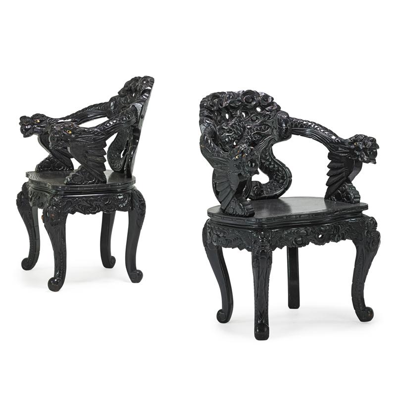 Appraisal: PAIR OF JAPANESE ARMCHAIRS Ebonized hardwood with carved vernacular design