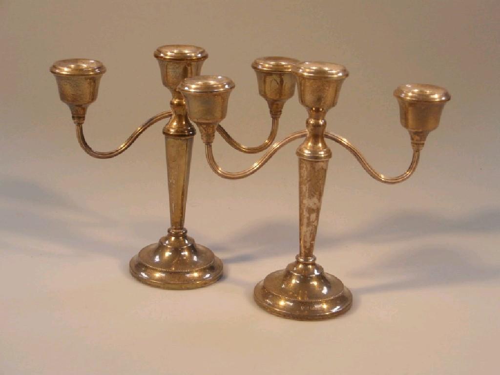 Appraisal: A pair of silver -light candelabra with loaded base Birmingham