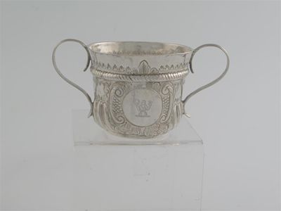 Appraisal: A Queen Anne small porringer with reeded scroll handles the