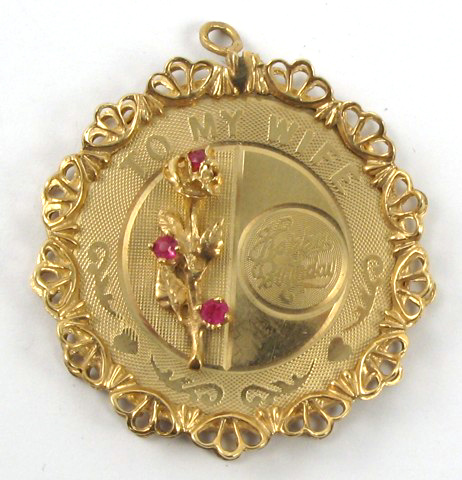 Appraisal: RUBY AND FOURTEEN KARAT GOLD PENDANT The round pendant is