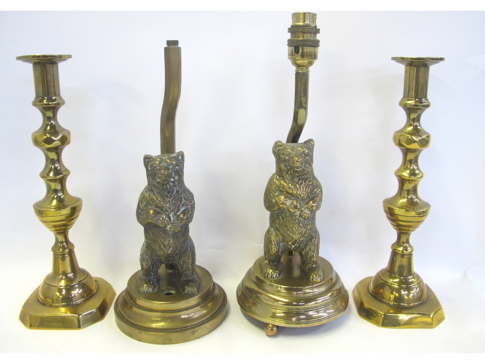 Appraisal: Two bear brass lamps and two gilt metal candlesticks