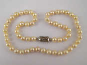 Appraisal: A cultured pearl necklace with a white metal tests silver