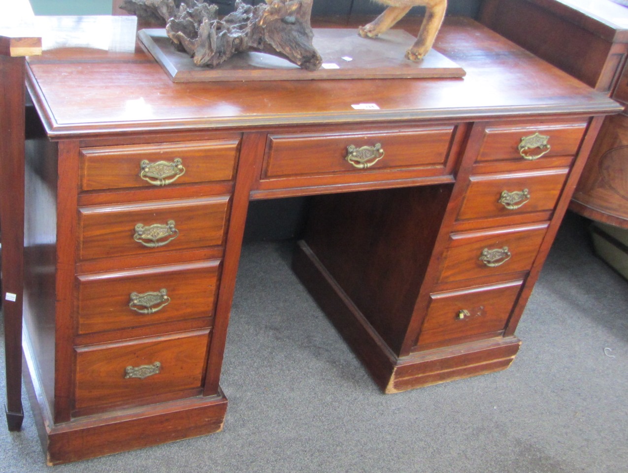 Appraisal: A late th century walnut kneehole desk with nine drawers