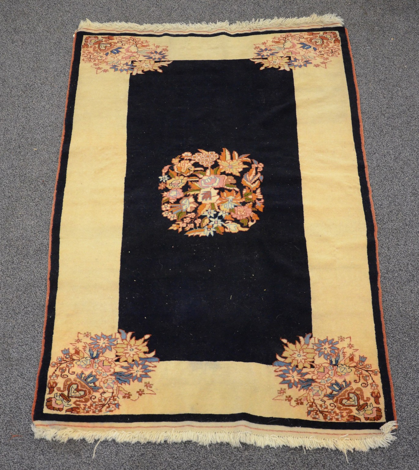 Appraisal: x Throw rug with black field with tan border floral