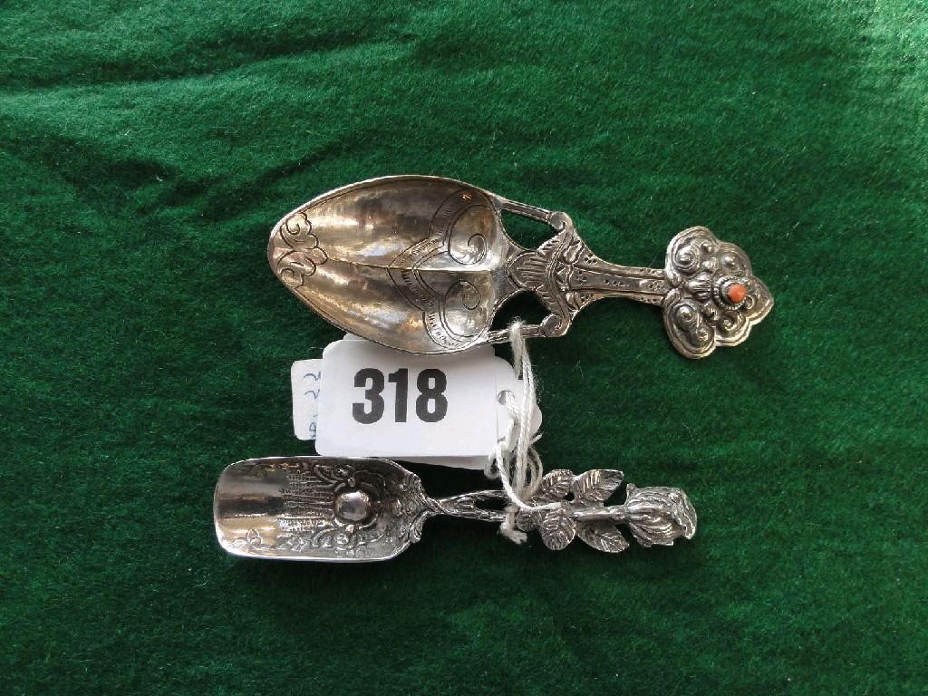 Appraisal: Two white metal spoons of stylised form one with a