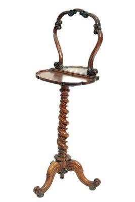 Appraisal: A Victorian walnut candlestand the raised mirror back to a