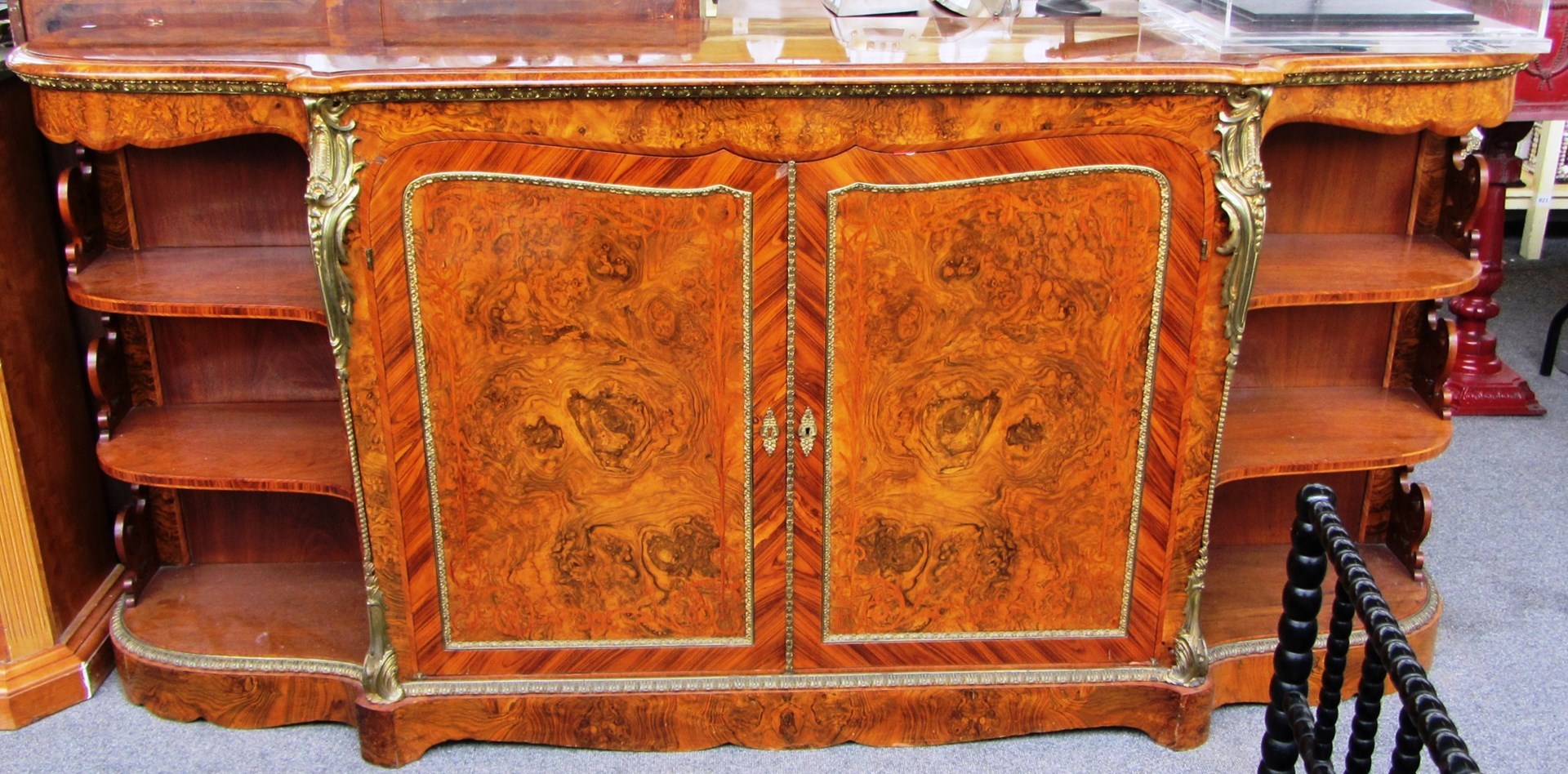 Appraisal: A Victorian tulipwood banded figured walnut gilt metal mounted credenza