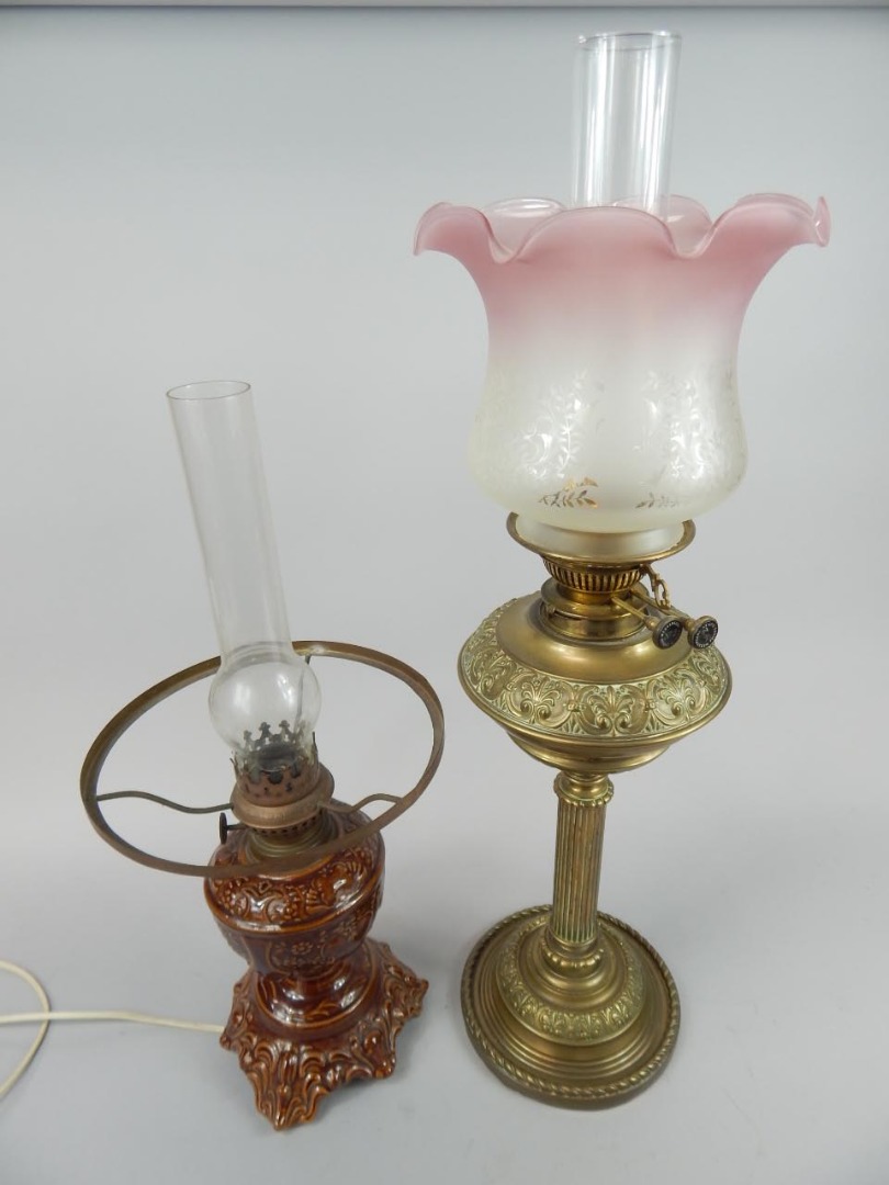 Appraisal: Oil lamps to include a brass column example with pink