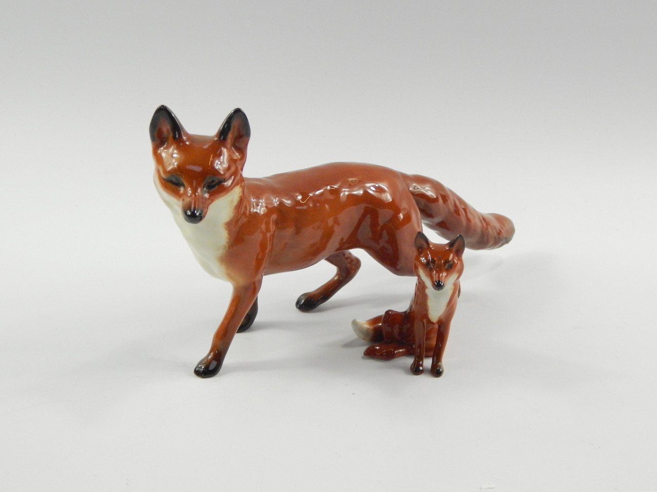 Appraisal: A Beswick standing fox and a smaller seated fox