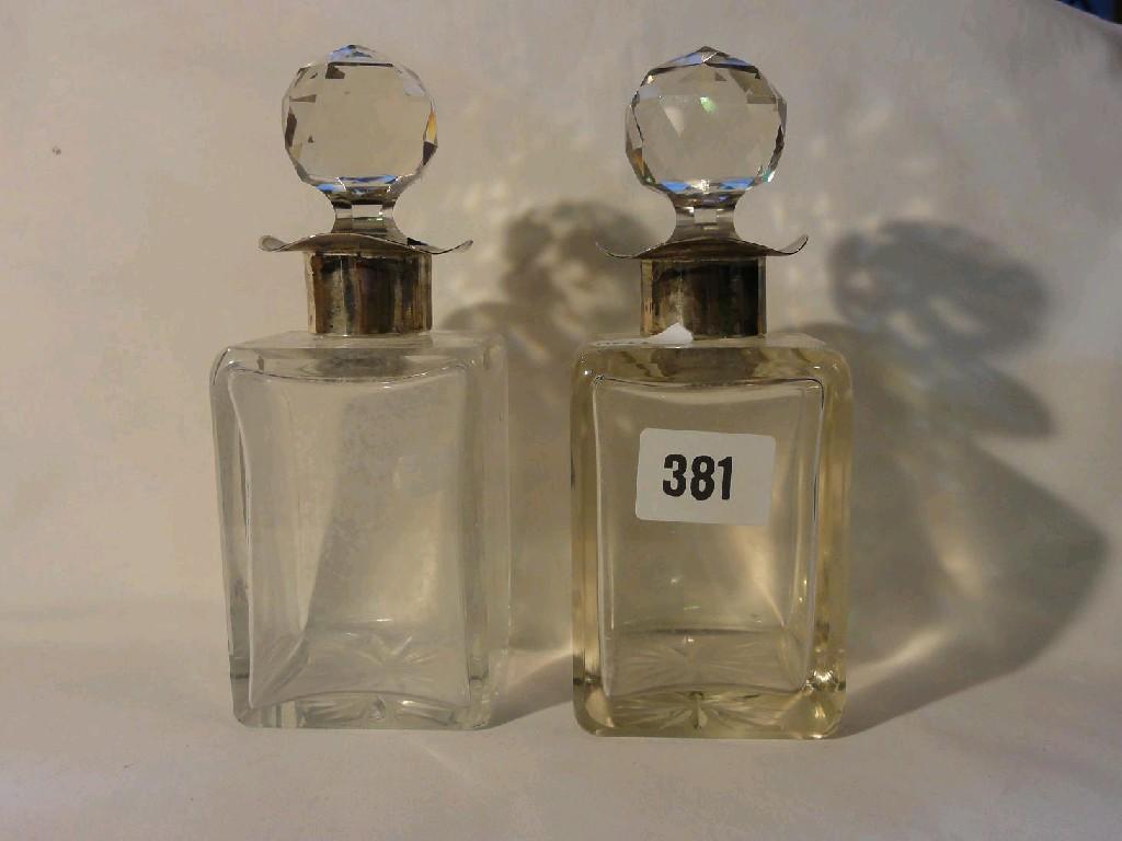 Appraisal: A pair of glass perfume bottles with silver mounted necks