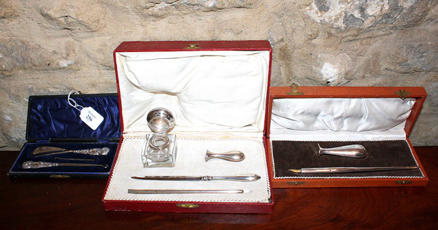 Appraisal: A CONTINENTAL LEATHER CASED DESK SET containing a glass and