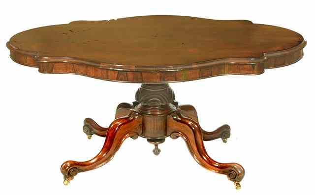 Appraisal: A VICTORIAN ROSEWOOD DINING TABLE with shaped oval top and