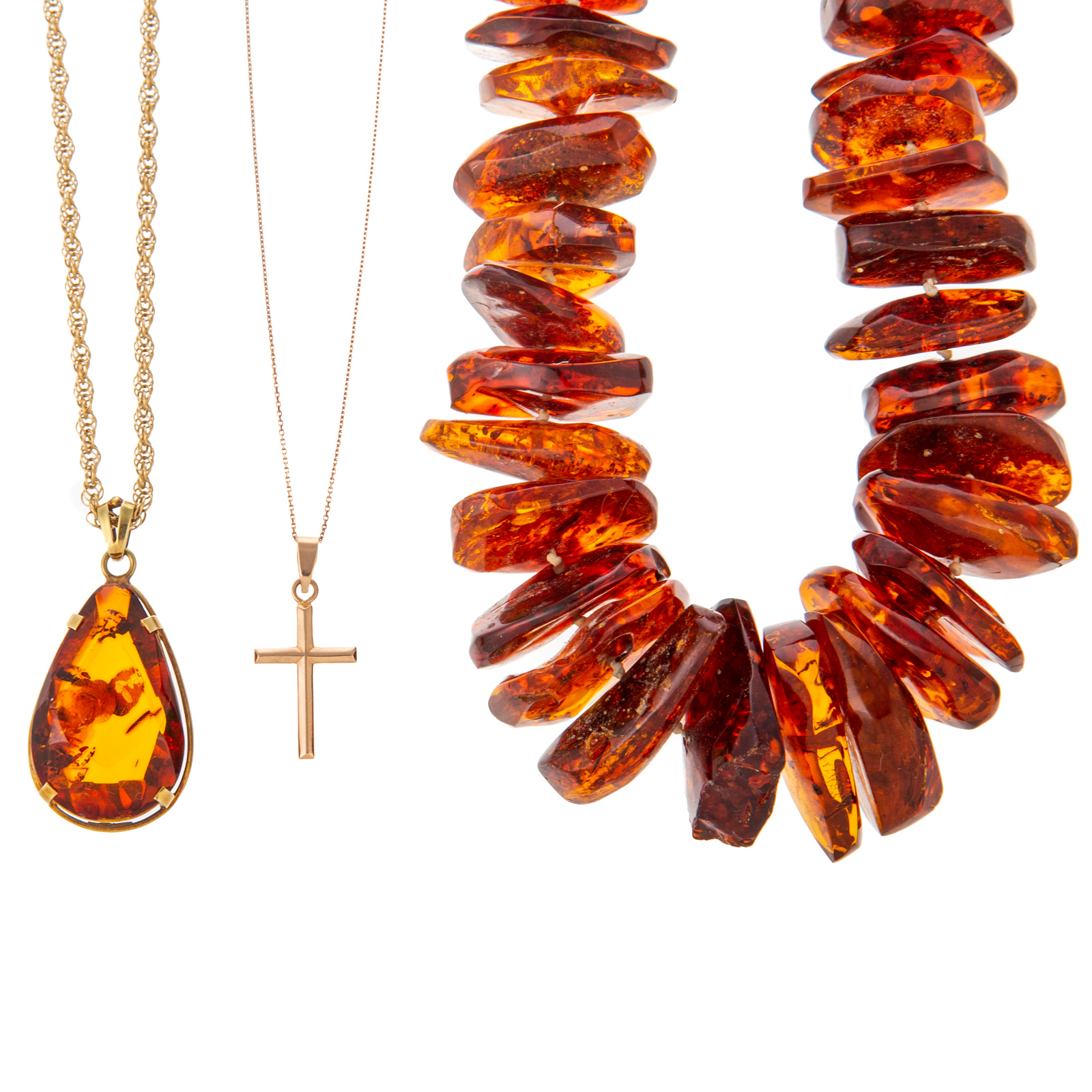 Appraisal: A K AMBER PENDANT STRAND OF AMBER BEADS CROSS K