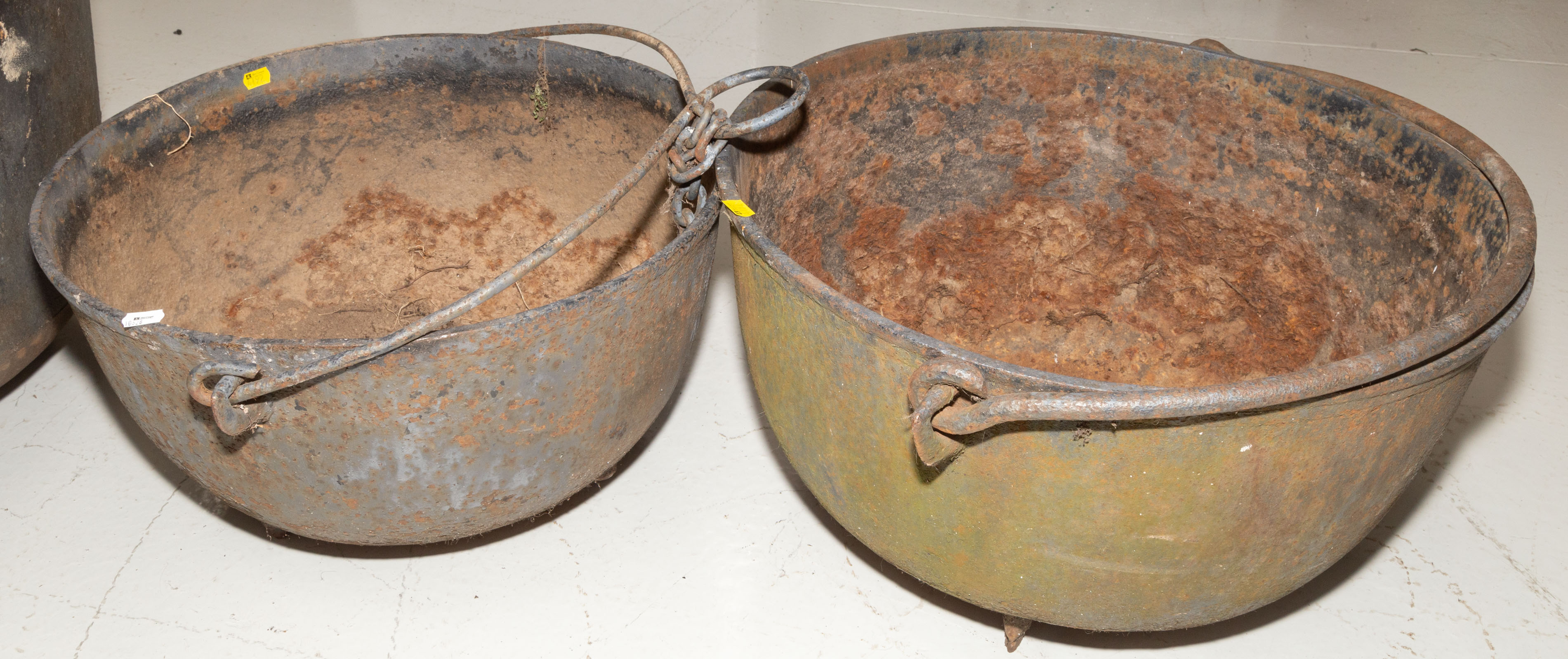 Appraisal: TWO AMERICAN CAST IRON CAULDRONS th century both with holes