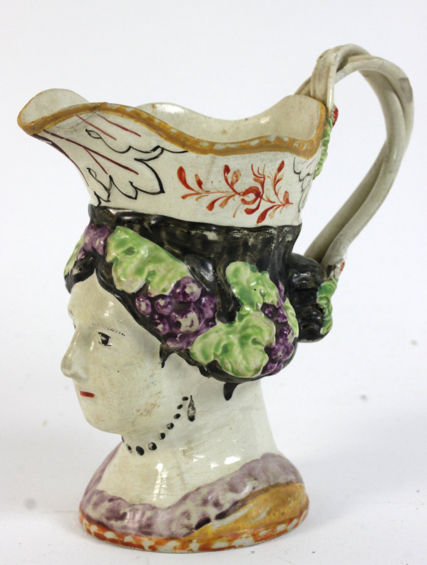 Appraisal: A Leeds pottery face mask jug representing Queen Charlotte cm