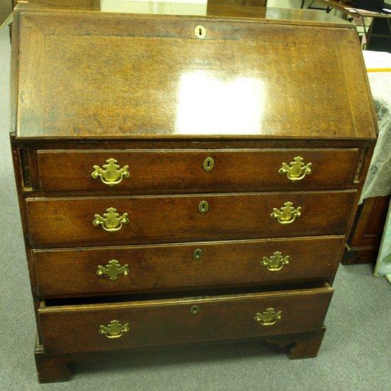 Appraisal: A George III oak bureau the fall front enclosing a