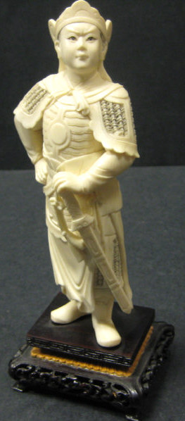 Appraisal: CHINESE CARVED IVORY WARRIOR Standing with sword on carved wood