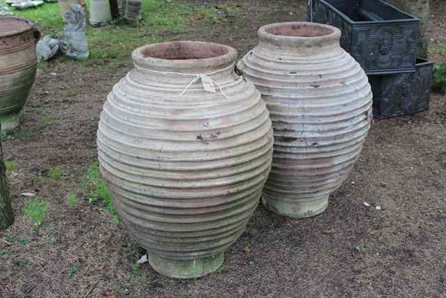 Appraisal: A LARGE PAIR OF TERRACOTTA OVOID RIBBED JARS high