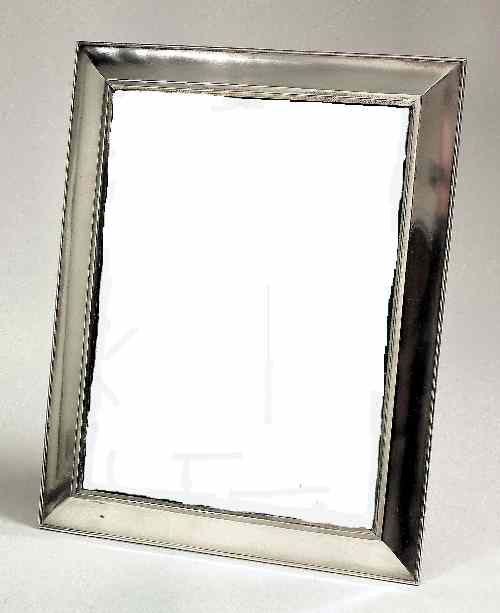 Appraisal: A modern silvery metal rectangular photograph frame with wide bevelled