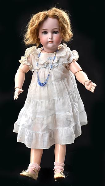 Appraisal: A KAMMER REINHARDT BISQUE HEAD GIRL DOLL on a composite