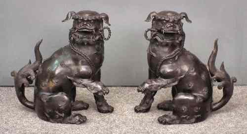 Appraisal: A pair of Chinese bronzed soft metal figures of seated