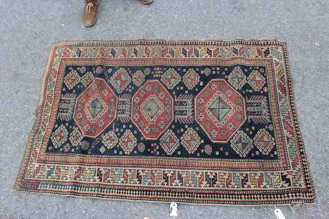 Appraisal: A CAUCASIAN SHIRVAN BLUE GROUND RUG decorated three central octagons