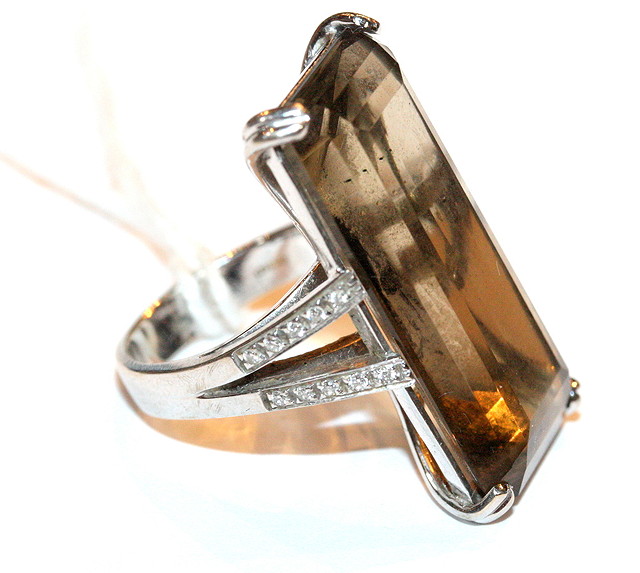 Appraisal: AN CT WHITE GOLD DRESS RING set with a baguette