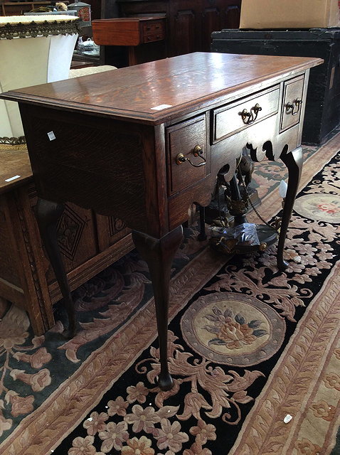 Appraisal: A GEORGIAN STYLE OAK LOWBOY with three frieze drawers brass