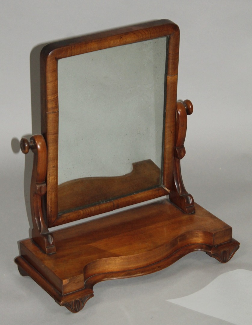 Appraisal: A Victorian mahogany table mirror the shaped glass flanked by