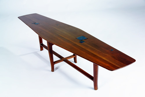 Appraisal: DUNBAR Fine walnut coffee table its boat-shaped top inset with