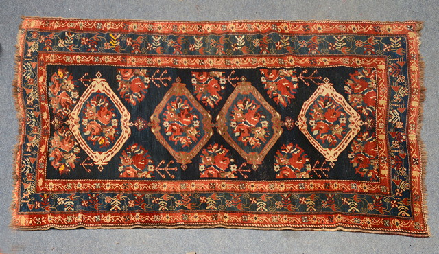 Appraisal: A LURI DARK BLUE GROUND RUG with a quadruple medallion