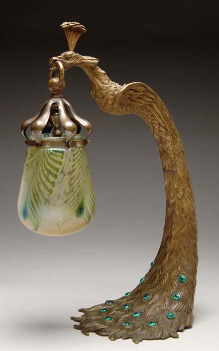 Appraisal: LOETZ PEACOCK LAMP Exceptional Loetz lamp features cast bronze base