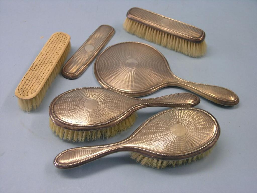 Appraisal: An engine-turned silver dressing table set pair of clothes brushes