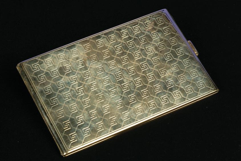 Appraisal: A MODERNIST GOLD PLATED CIGARETTE CASE with swastika and diaper