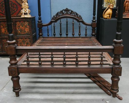 Appraisal: A Four Poster Calcutta Bed with turned headboard central pierced