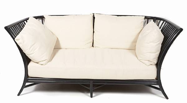 Appraisal: An ebonized bamboo sofa with loose cushions McGuire Furniture Company