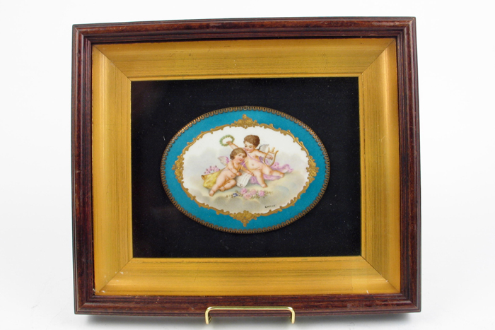 Appraisal: A FRENCH PORCELAIN WALL PLAQUE hand painted with putti and