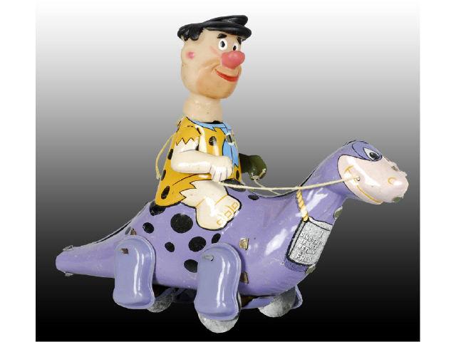 Appraisal: Marx Tin Wind-Up Flintstone on Dino Toy with Box Description