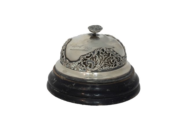 Appraisal: A silver mounted circular wind-up table bell with pierced decoration