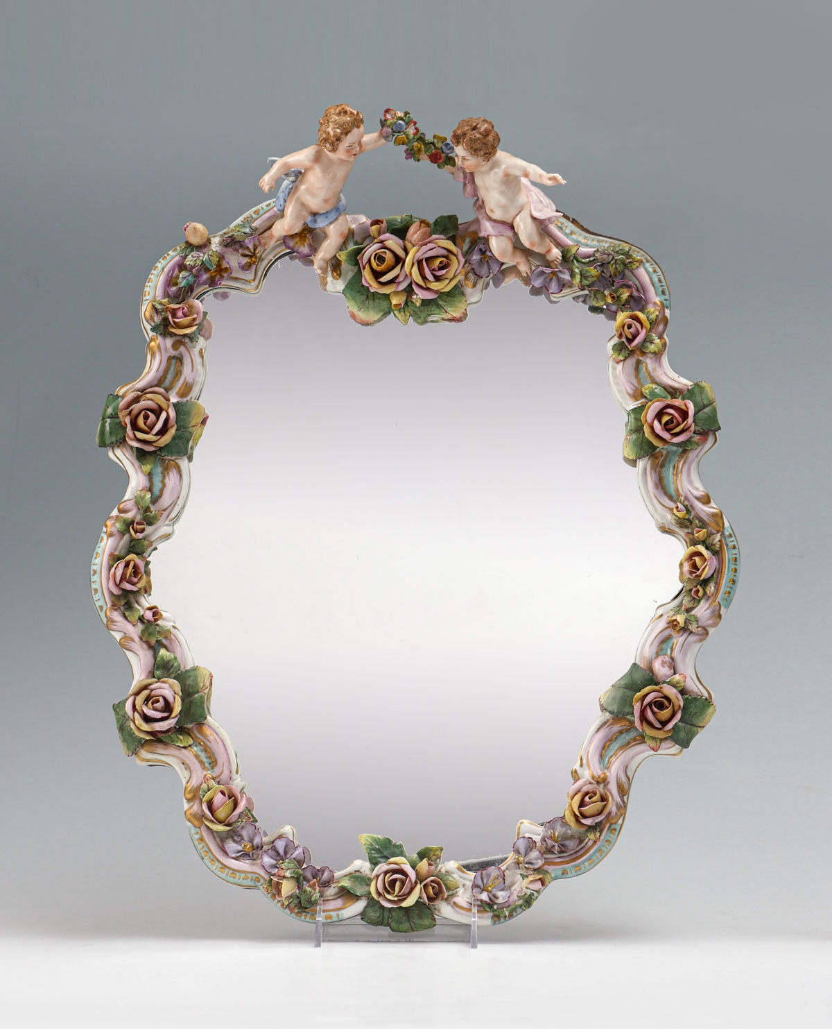 Appraisal: MEISSEN STYLE PORCELAIN MIRROR Surmounting cherubs with bouquets Porcelain segmented