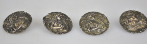 Appraisal: Set of four Art Nouveau cast buttons featuring girl playing