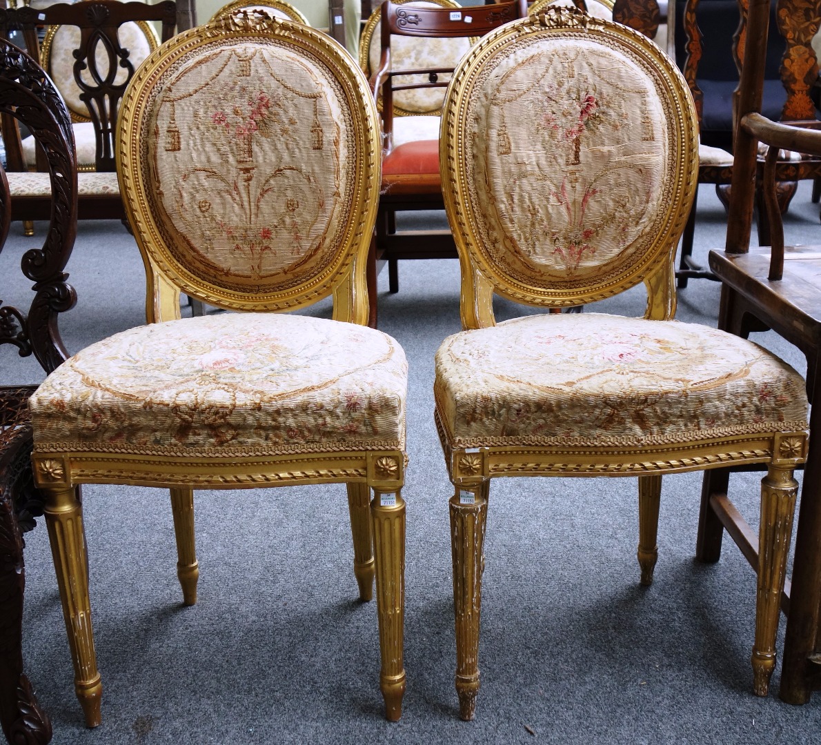 Appraisal: A pair of Louis XVI style gilt carved side chairs