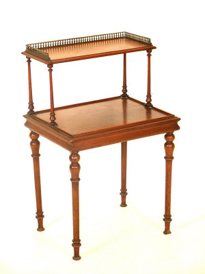 Appraisal: A mahogany two tier table the brass three quarter galleried